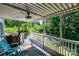 A shaded back porch with a ceiling fan overlooking a green backyard with mature trees at 110 Club Dr, Mooresville, NC 28115