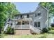 Exterior of home showcasing backyard with covered porch and stairs leading to the lush yard at 110 Club Dr, Mooresville, NC 28115