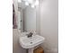 Small bathroom featuring white pedestal sink, silver fixtures, mirror, and white trim at 110 Club Dr, Mooresville, NC 28115