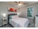 Comfortable bedroom featuring a queen bed, coordinating side tables, and a sunny window at 110 Club Dr, Mooresville, NC 28115