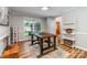 Dining room with a wooden table, windows overlooking the yard, and a white bookshelf at 110 Club Dr, Mooresville, NC 28115