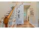 Bright and airy foyer with wood laminate flooring, staircase to the second floor, and decorative accents at 110 Club Dr, Mooresville, NC 28115