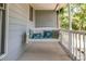 Relax on this charming front porch swing with decorative pillows and painted wood railing at 110 Club Dr, Mooresville, NC 28115