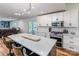 Open-concept kitchen with white cabinets, stainless steel appliances and island with counter seating, connects to the living room at 110 Club Dr, Mooresville, NC 28115