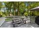 Back deck featuring outdoor dining furniture and a grill, perfect for entertaining and enjoying the natural surroundings at 11329 Torino Rd, Matthews, NC 28105