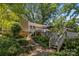 Lush backyard featuring a multi-level deck accessible by steps and surrounded by verdant trees and landscaping at 11329 Torino Rd, Matthews, NC 28105