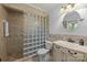 Well-appointed bathroom featuring tiled shower with glass blocks, vanity, and neutral color palette at 11329 Torino Rd, Matthews, NC 28105