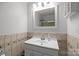 Well-lit bathroom featuring tile accents, a mirror, and white vanity providing a clean and functional space at 11329 Torino Rd, Matthews, NC 28105