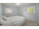 Bright bedroom featuring neutral walls, carpeting, and natural light from two windows at 11329 Torino Rd, Matthews, NC 28105
