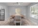Bright dining room with wooden table, white chairs, and natural light from multiple windows at 11329 Torino Rd, Matthews, NC 28105