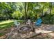 Cozy fire pit area with colorful Adirondack chairs, perfect for outdoor entertaining at 11329 Torino Rd, Matthews, NC 28105