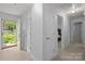 Bright hallway showcasing light wood floors, neutral paint, and doorway with bedroom view at 11329 Torino Rd, Matthews, NC 28105