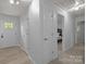 Inviting hallway with neutral paint, wood-look flooring, and easy access to multiple bedrooms at 11329 Torino Rd, Matthews, NC 28105