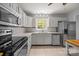 Well-equipped kitchen with stainless steel appliances, white cabinets, and modern countertops at 11329 Torino Rd, Matthews, NC 28105
