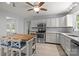 Bright kitchen with white cabinetry, stainless steel appliances, and a charming butcher block island at 11329 Torino Rd, Matthews, NC 28105