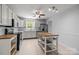 Modern kitchen features white cabinets, stainless steel appliances, and ample counter space at 11329 Torino Rd, Matthews, NC 28105