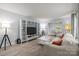 Cozy living room showcasing built-in shelving, neutral walls, and seamless flow to the dining area at 11329 Torino Rd, Matthews, NC 28105