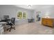 Inviting living room featuring neutral walls, light wood floors, and large windows for natural light at 11329 Torino Rd, Matthews, NC 28105