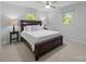 Comfortable main bedroom with a large bed, neutral walls, and natural light from two windows at 11329 Torino Rd, Matthews, NC 28105