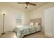 Well-lit bedroom featuring a ceiling fan, white walls, and a window at 121 Pelham Ln, Fort Mill, SC 29715