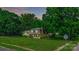 Suburban home with manicured front lawn, dormer windows, and mature trees at 121 Pelham Ln, Fort Mill, SC 29715