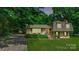 Inviting home with a brick exterior, lush lawn, and a convenient carport at 121 Pelham Ln, Fort Mill, SC 29715