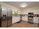 This kitchen showcases white cabinetry, wood flooring, and stainless steel appliances at 121 Pelham Ln, Fort Mill, SC 29715