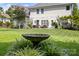 Manicured backyard with a birdbath feature, outdoor furniture, and a well-maintained lawn at 129 Nims Spring Dr, Fort Mill, SC 29715