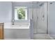 Serene bathroom featuring a soaking tub next to a window and a separate glass shower at 129 Nims Spring Dr, Fort Mill, SC 29715