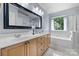 Bright bathroom features double sinks, a large mirror, and a soaking tub by the window at 129 Nims Spring Dr, Fort Mill, SC 29715