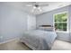 Cozy bedroom with neutral walls, ceiling fan, double door closet and a bright window with green views at 129 Nims Spring Dr, Fort Mill, SC 29715