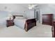 Spacious bedroom with a ceiling fan, neutral walls, and elegant furniture, and an ensuite door at 129 Nims Spring Dr, Fort Mill, SC 29715