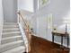 Bright foyer with hardwood floors, staircase, and elegant entry table at 129 Nims Spring Dr, Fort Mill, SC 29715