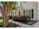 Inviting front entrance with black door, decorative shrubbery, and meticulous landscaping at 129 Nims Spring Dr, Fort Mill, SC 29715