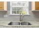 Kitchen detailing featuring stainless steel sink, granite countertops, and subway tile backsplash at 129 Nims Spring Dr, Fort Mill, SC 29715