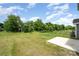 Expansive backyard with lush green grass and a concrete patio, great for relaxing and entertaining at 12912 Canterbury Castle Dr, Charlotte, NC 28273