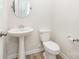 Charming half bathroom features a pedestal sink, oval mirror, and tile flooring at 12912 Canterbury Castle Dr, Charlotte, NC 28273
