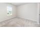 Bedroom featuring carpeted floor and a window providing natural light, creating a cozy atmosphere at 12912 Canterbury Castle Dr, Charlotte, NC 28273