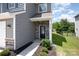 Charming home entrance with a stone accent wall and well-maintained landscaping at 12912 Canterbury Castle Dr, Charlotte, NC 28273