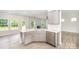 Kitchen view showcases quartz countertop island with stainless steel dishwasher at 12912 Canterbury Castle Dr, Charlotte, NC 28273