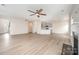 Spacious open-concept living room with a fireplace, ceiling fan, and natural light at 12912 Canterbury Castle Dr, Charlotte, NC 28273