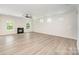 Large living room has wood floors, fireplace, and natural light at 12912 Canterbury Castle Dr, Charlotte, NC 28273