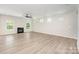 Large living room has wood floors, fireplace, and natural light at 12912 Canterbury Castle Dr, Charlotte, NC 28273