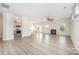 Open-concept living room with a fireplace, ceiling fan, and natural light at 12912 Canterbury Castle Dr, Charlotte, NC 28273