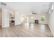 Spacious living room featuring a fireplace, wood flooring, and an open layout to the kitchen at 12912 Canterbury Castle Dr, Charlotte, NC 28273