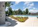 Community pool area featuring mature trees and comfortable seating, ideal for relaxation and recreation at 12912 Canterbury Castle Dr, Charlotte, NC 28273