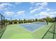 Well-maintained community tennis court with fresh green and blue surface, ready for play at 12912 Canterbury Castle Dr, Charlotte, NC 28273