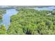 An aerial view showcasing a heavily wooded lot with lake access at 140 Rustic Way Ln, Mooresville, NC 28117