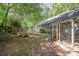 View of backyard with chicken coop, lush green lawn, and privacy provided by mature trees, perfect for outdoor living at 140 Rustic Way Ln, Mooresville, NC 28117