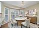 Dining room with white marble top table and bay windows at 140 Rustic Way Ln, Mooresville, NC 28117